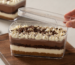 Crystal clear bakery packaging box with layered chocolate dessert by Navin Plast showcasing premium food-grade transparent packaging for cakes and desserts.